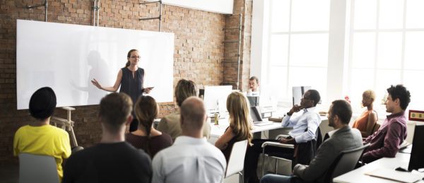 Photo of typical adult learning classroom with instructor in front of whiteboard