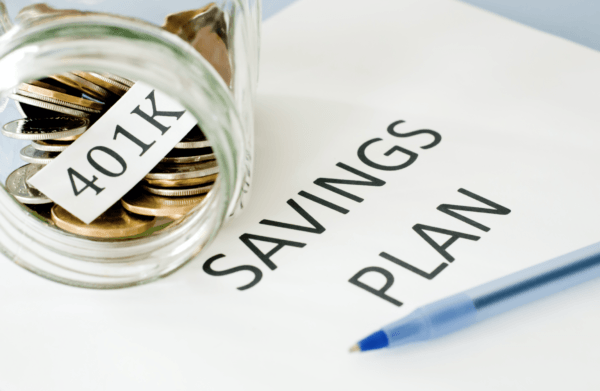 Photo showing "401K" and "Savings Plan" materials on desk