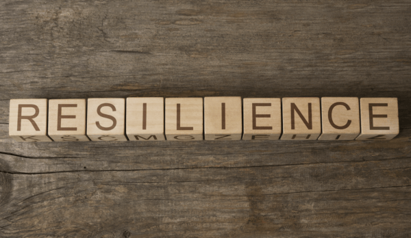 Toy block letters spelling out "resilience"