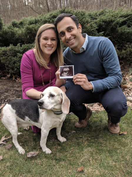 Vijay and his wife holding a sonogram photo