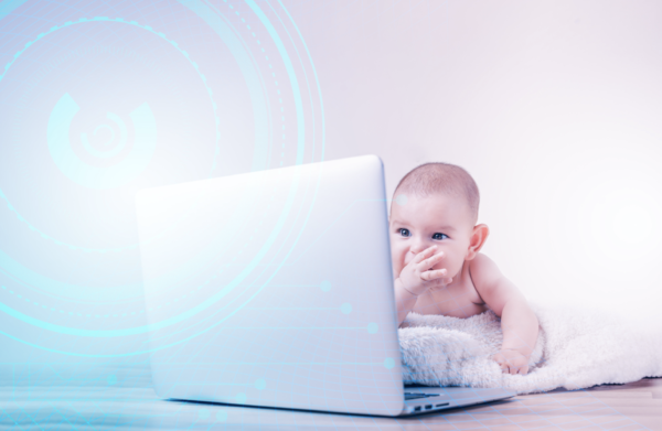 Photo of a baby looking at a laptop