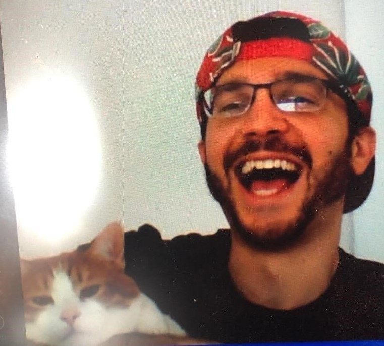 A person holding a cat Description automatically generated