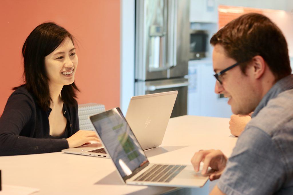 Two FMP Employees with laptops engaging