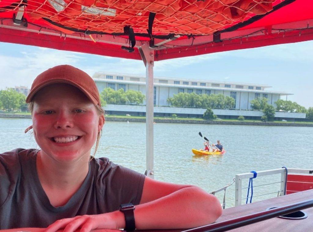 Image of Savannah enjoying time in the shade on a boat