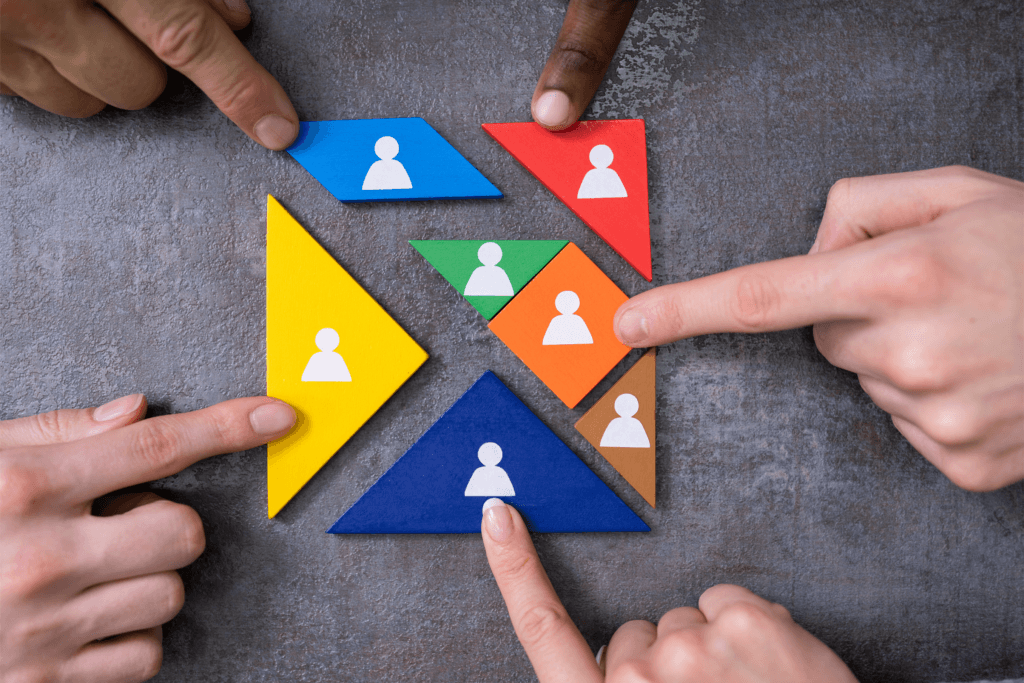 Diverse set of hands putting a puzzle together