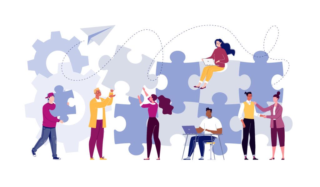 Illustration of a team working together to put together a large puzzle, intended to represent team work.