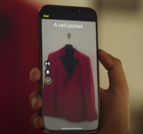 hand holding an Apple phone, using the Detection Mode in Magnifier to identify a red jacket.