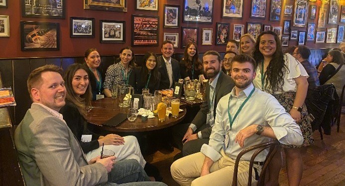An image of FMPers posing together for a group picture at a restaurant.