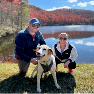 Image of Shelby hiking in Wintergreen, Virginia with her husband, Brad and dog, Louie.